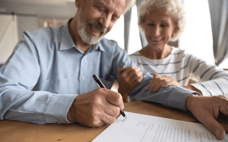 Retired couple signing for a mortgage in Spain